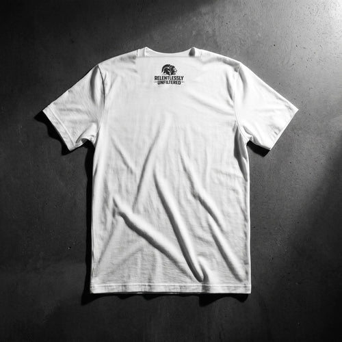 Comfort Is Expensive men's white tee, back: Relentlessly Unfiltered lion logo below the collar