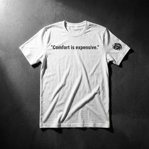 Comfort Is Expensive men's white tee, front: one-line "Comfort is expensive." chest print with the Relentlessly Unfiltered lion on the sleeve